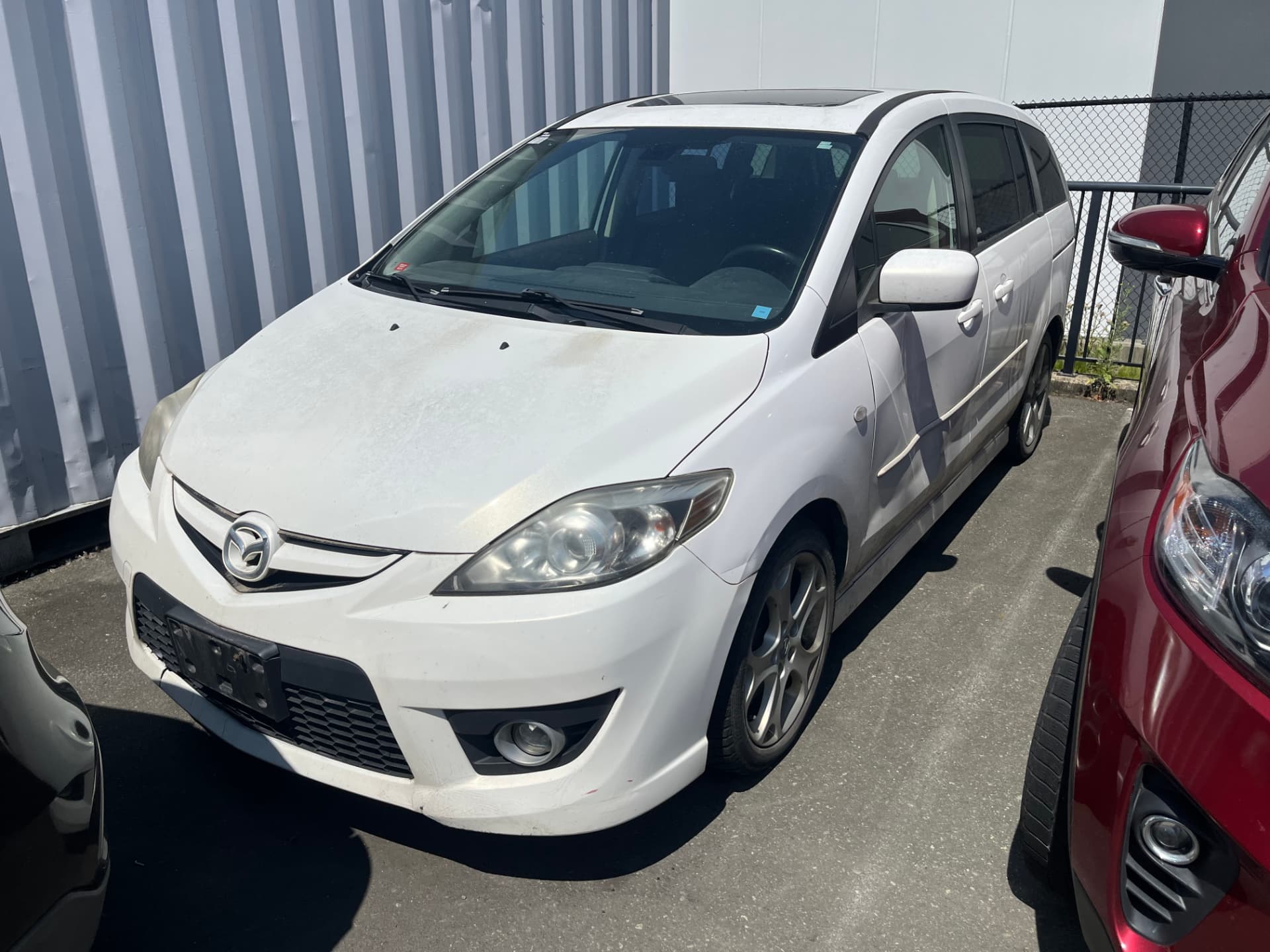 Family minivan parked at the yard after scrap car removal Coquitlam pickup