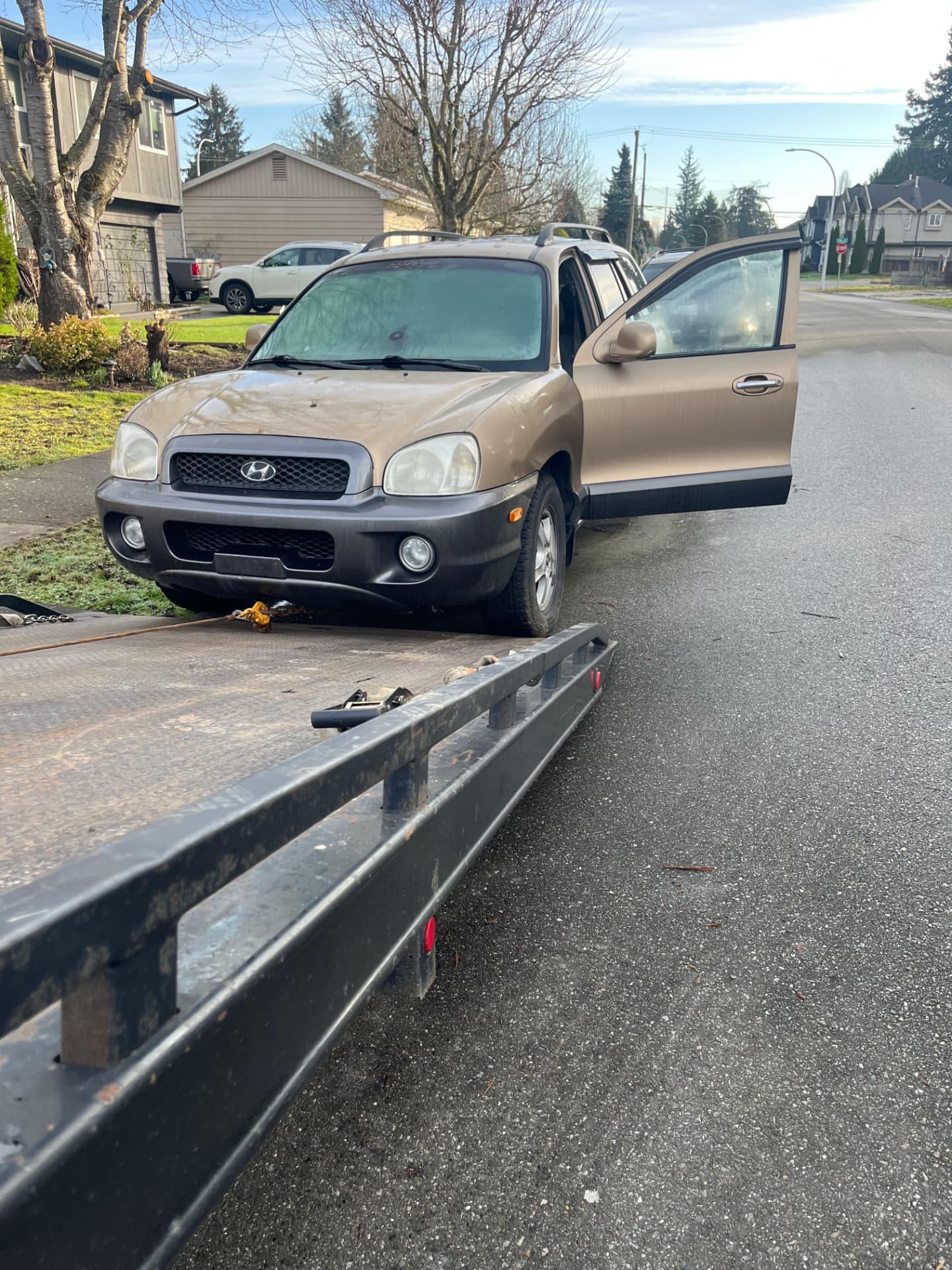 Gold Hyundai Santa Fe being winched onto the deck for scrap car removal Port Coquitlam