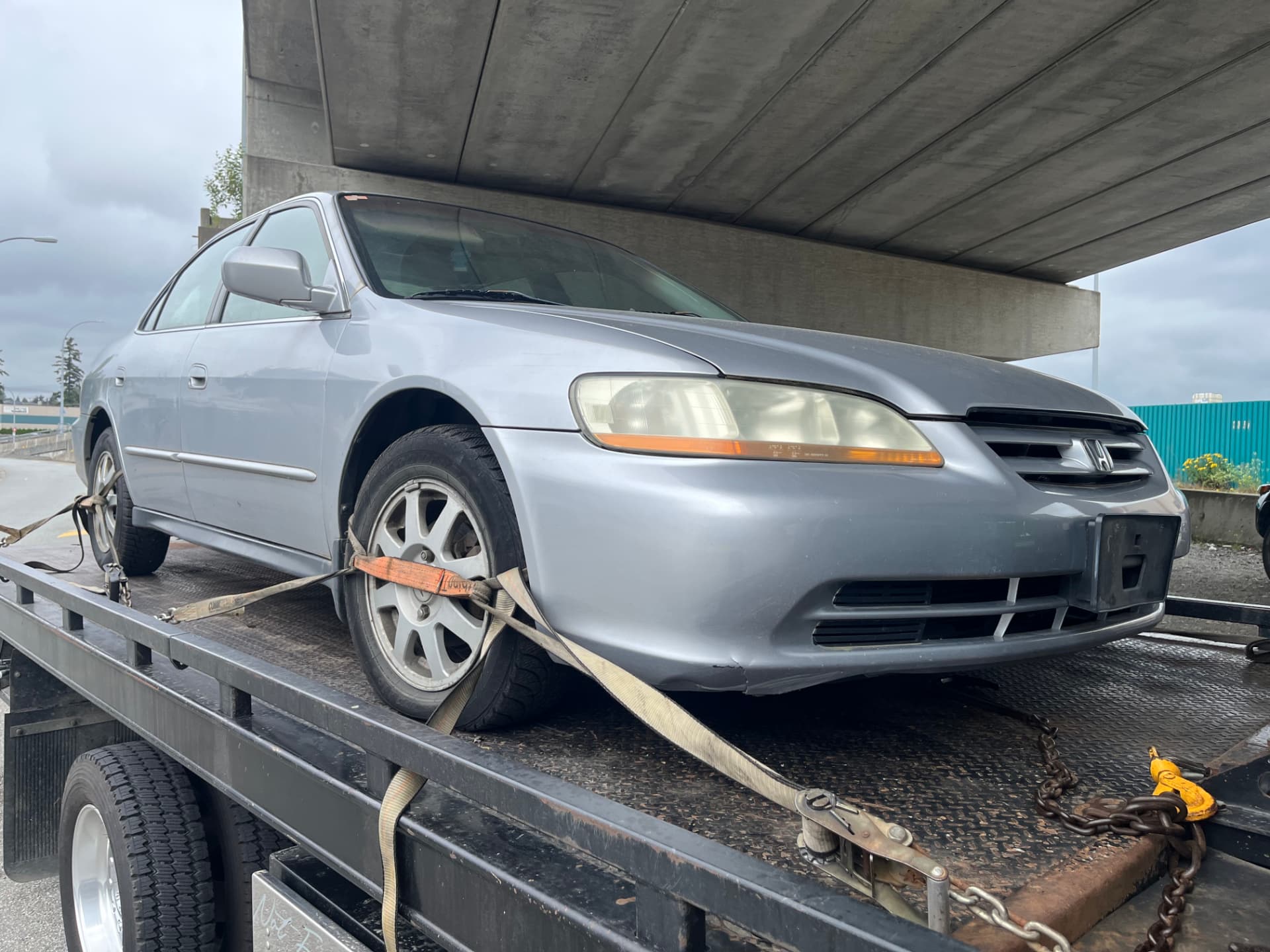 Silver Honda Accord strapped to the deck during scrap car removal Coquitlam