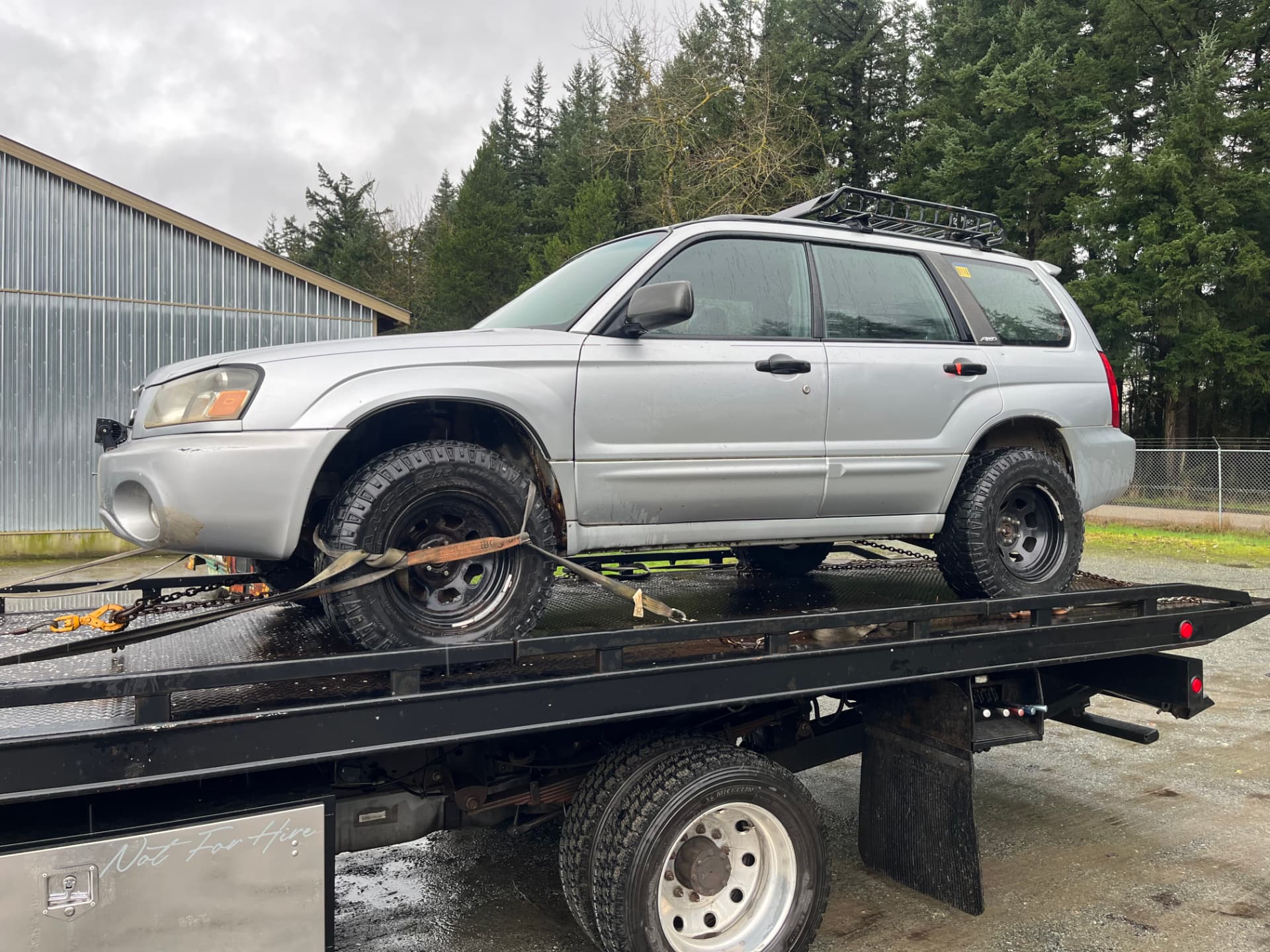 Silver Subaru Forester on the flat deck for scrap car removal Coquitlam