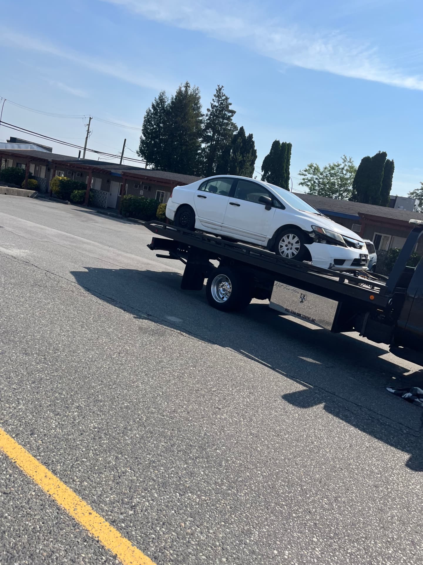 White Honda Civic loaded on the flat deck during scrap car removal Coquitlam